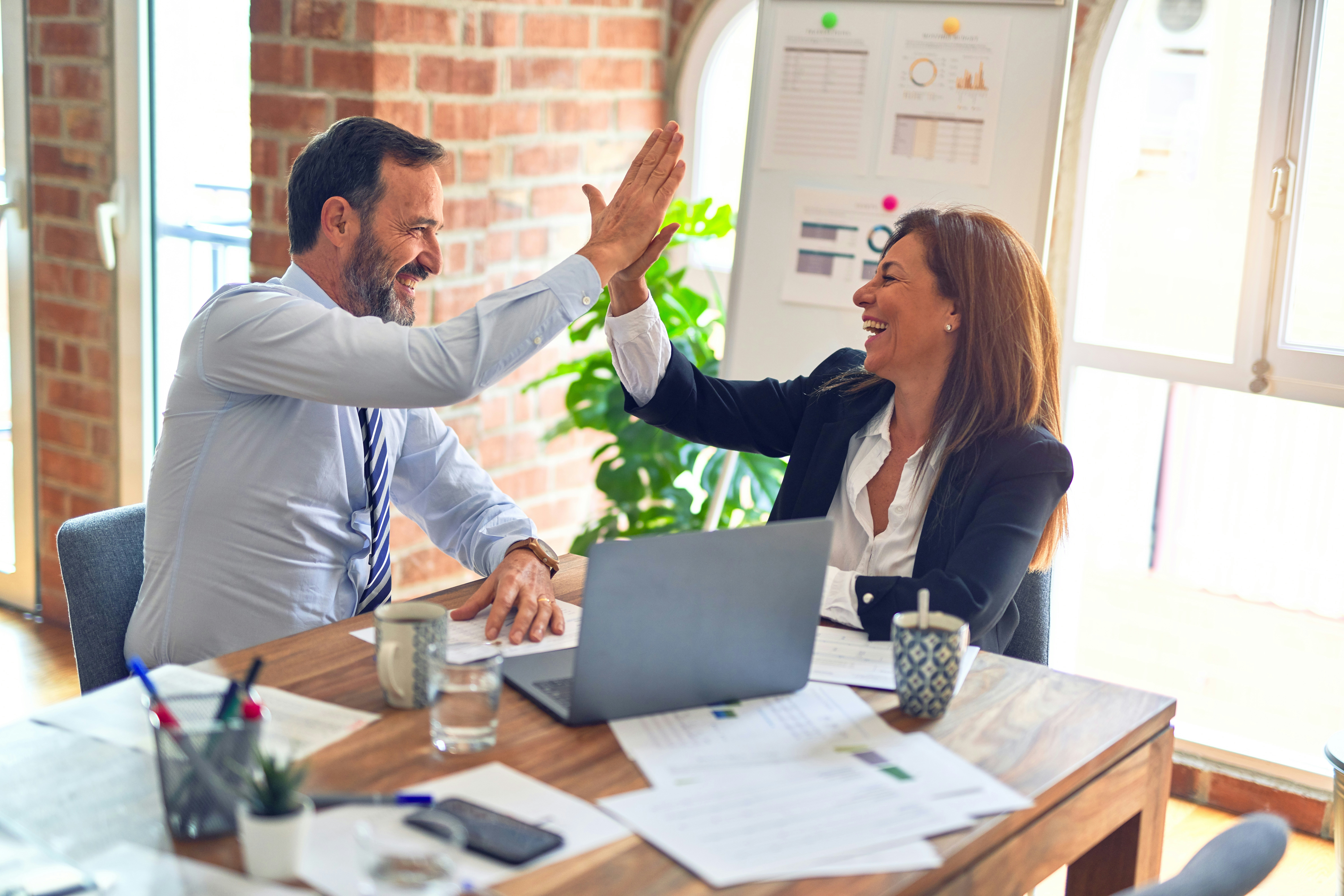 Two business partners feeling aligned in their goals after a counselling session to solve their business relationship problems with a professional therapist