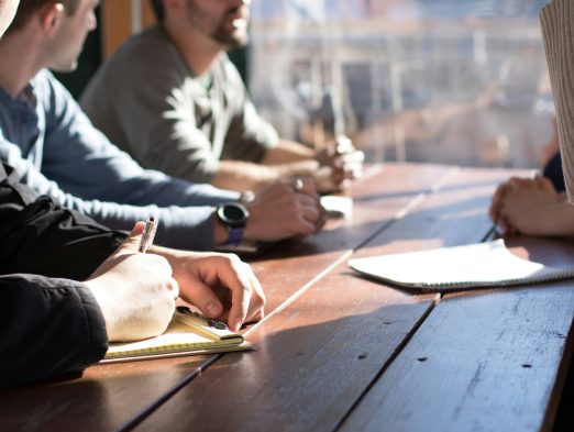 A collaborative business conflict resolution session, where partners are guided by a therapist to improve communication and trust.